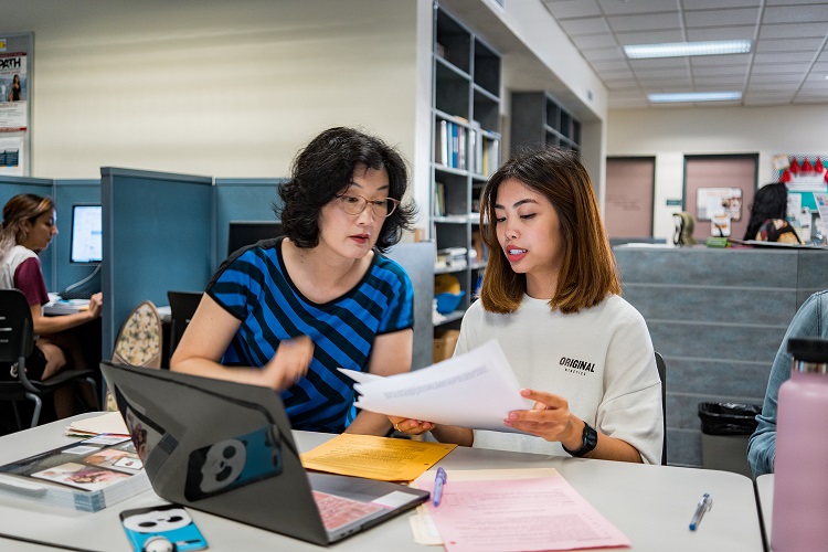 Communication Teacher with Student in the Communication Lab